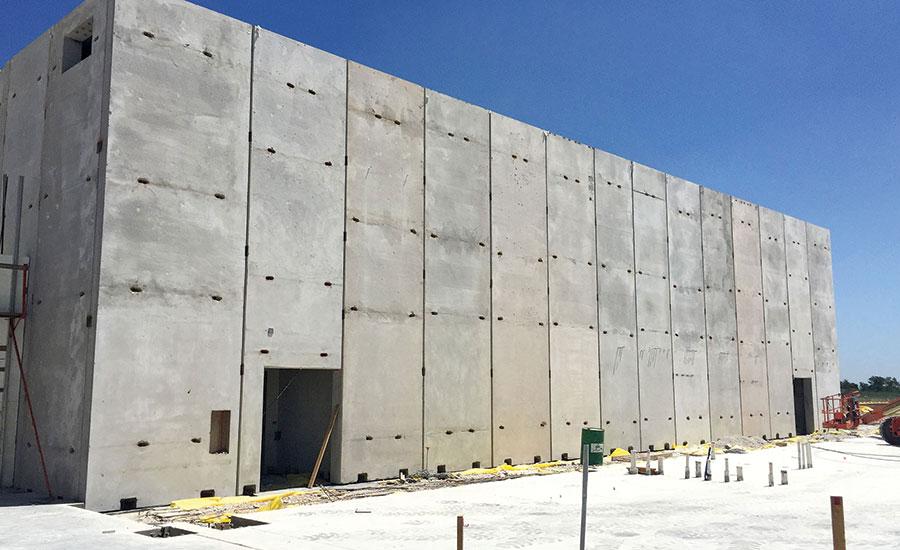A tornado-proof building with a door is constructed out of conjoined concrete T-walls